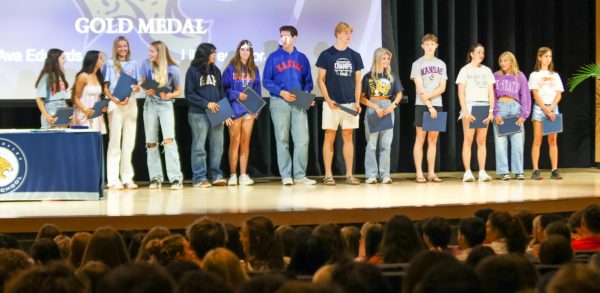 Standing proudly 13 seniors receive a bronze award for community service.